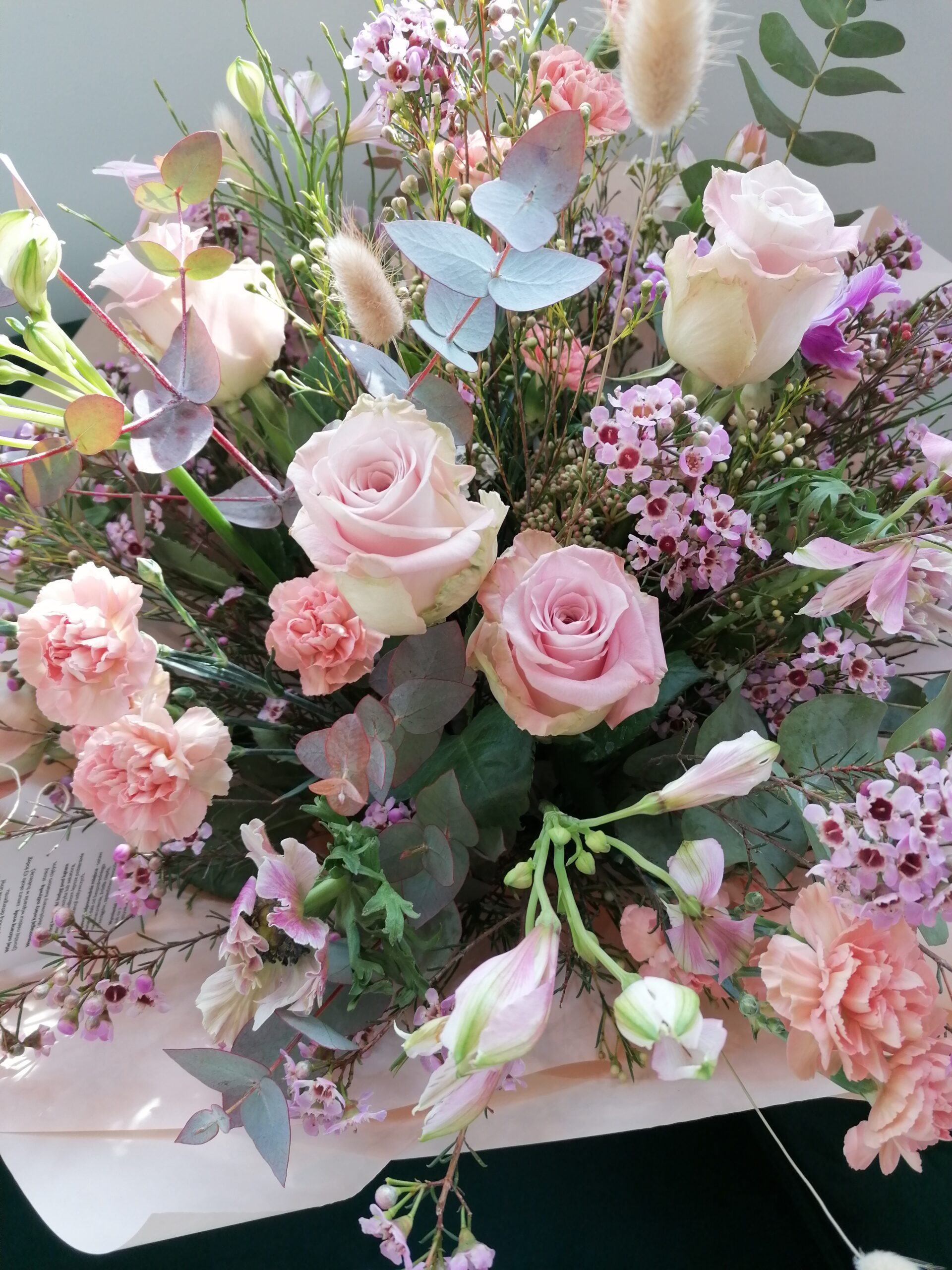 This is a unique, subtle, feminine way to give the gift of a special bouquet. Starring roses, alstroemeria, carnations, wax and eucalyptus. This bouquet brings a blush of