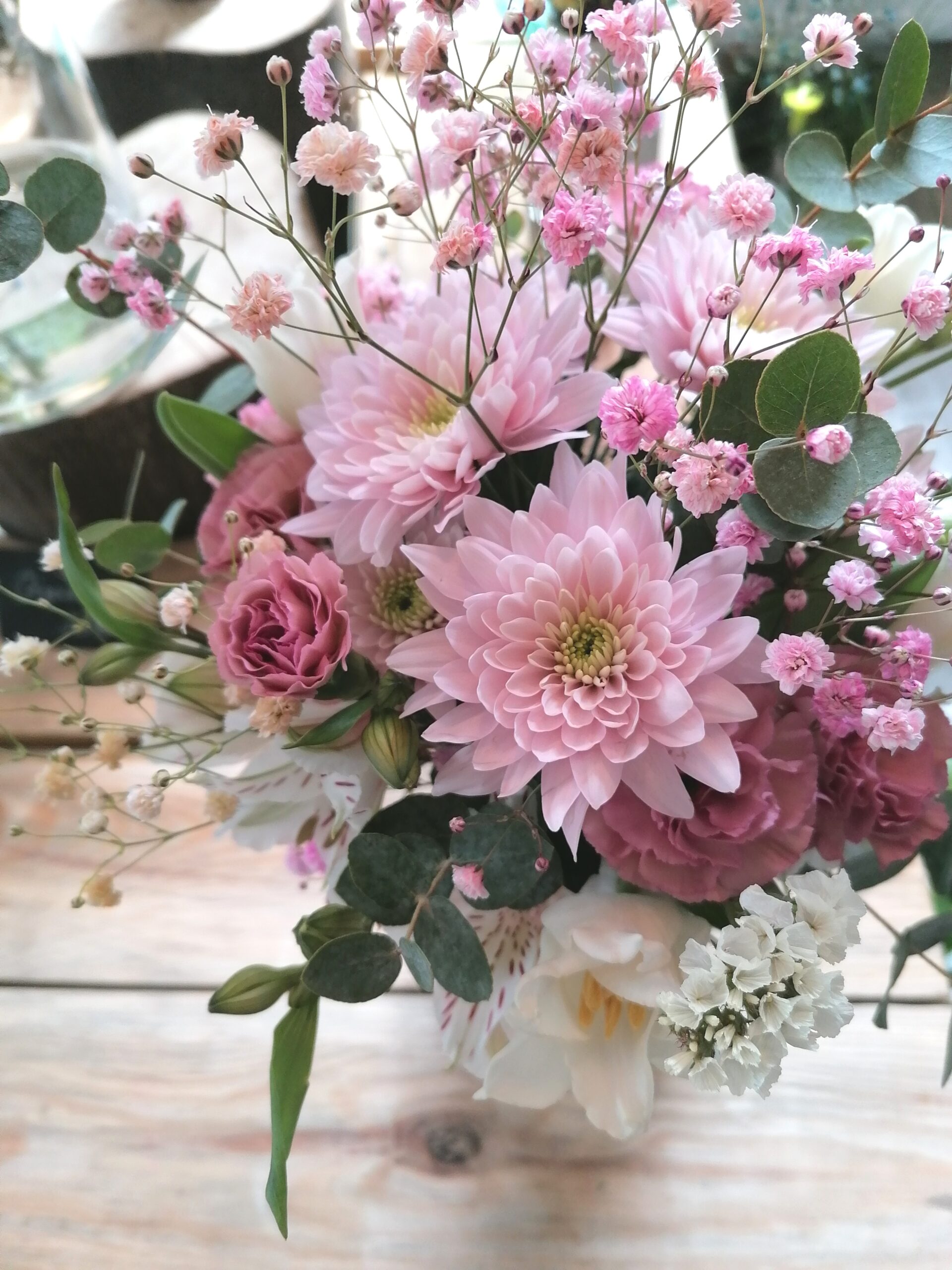 The mini bouquet is a compact little bouquet. Charming thanks to its dome form and pastel pink tones. Filigree additions in the form of gypsophila and white floral ornaments give it a unique charm.