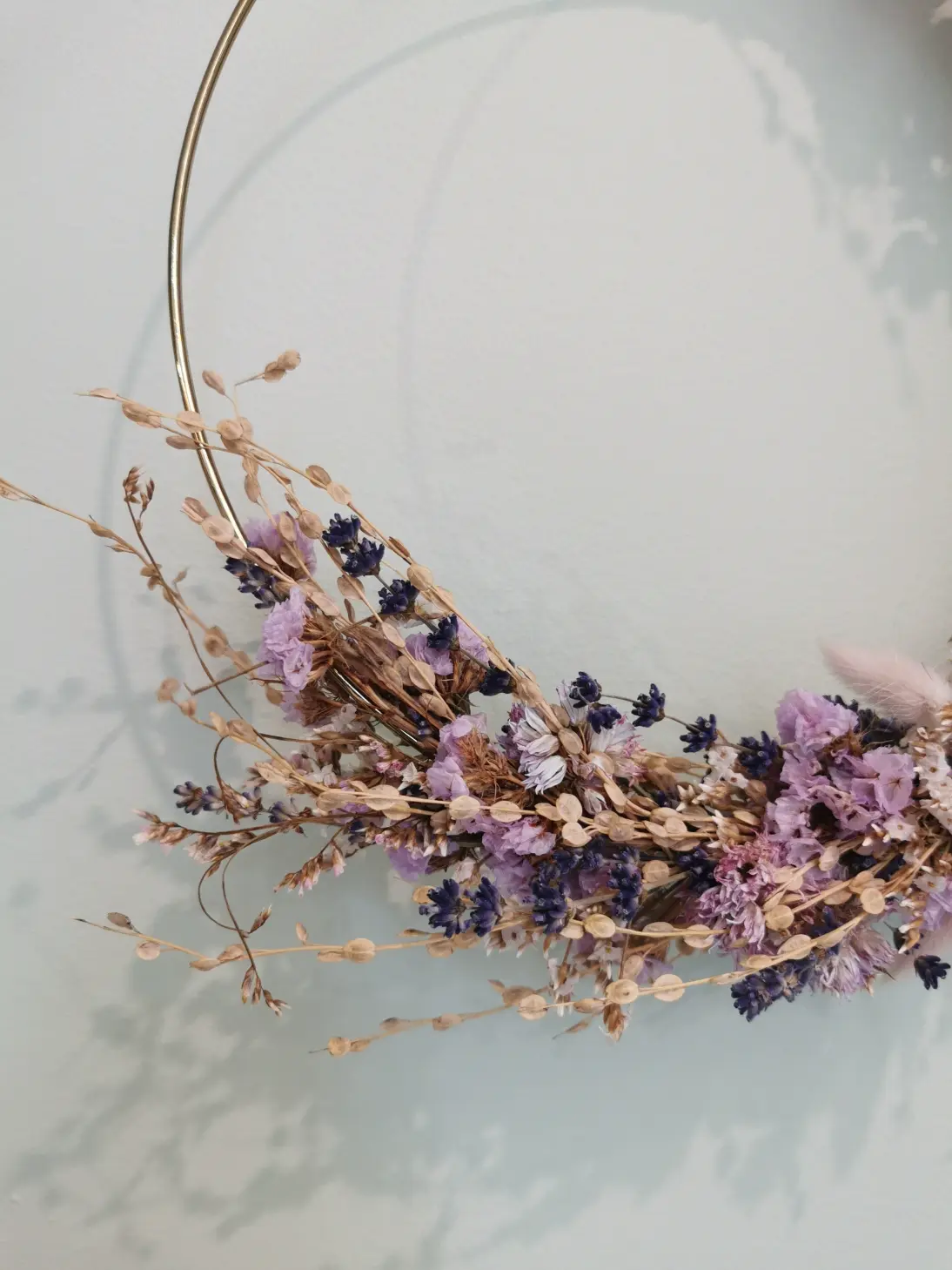 Pastel, light with an accent of grasses. Made with dried: blewworms, bayberry, lavender and field grasses.